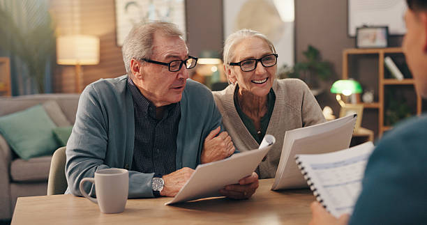 Senior couple reviewing documents with an advisor